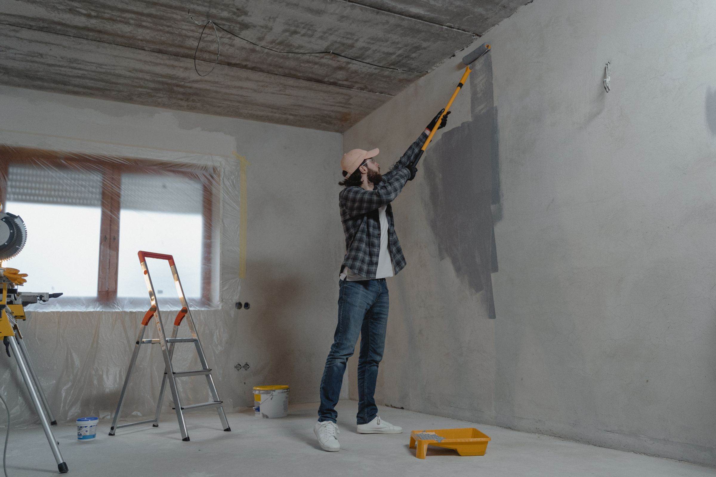 Painter rolling a fresh coat onto an interior wall